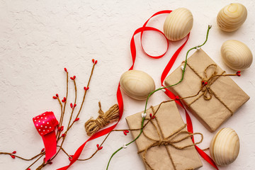 Zero waste Easter concept. Wooden eggs, gifts in craft paper. Not plastic, eco trend. White putty...