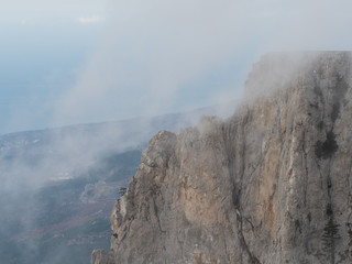 Clouds drift among the rocky cliffs.