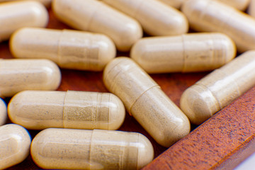 capsule drugs to fight viruses that are isolated against a white background and copy space, macro