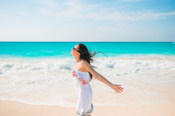 Fototapeta na wymiar Young woman enjoying the sun sunbathing by perfect turquoise ocean