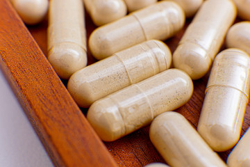 capsule drugs to fight viruses that are isolated against a white background and copy space, macro