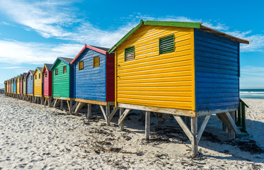 Colorful wooden beach huts on Muizenberg beach near Cape Town, a famous place for surfing, South Africa.