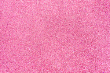 Hot pink glitter twinkle abstract New Year or Christmas holiday background with sparkles. Modern luxury mock up with sequins. Texture of colored porous rubber with spangles