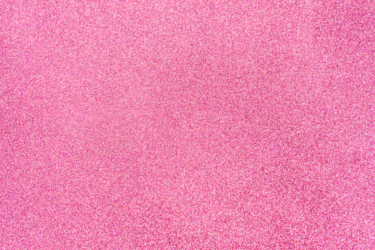 Hot pink glitter twinkle abstract New Year or Christmas holiday background with sparkles. Modern luxury mock up with sequins. Texture of colored porous rubber with spangles