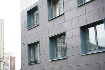 Frontal view of facade of building with a lot of windows.