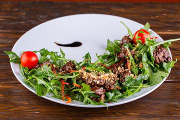 Warm veal salad with rukkola and tomatoes