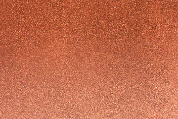 Salmon glitter twinkle abstract autumn or Christmas holiday background with sparkles. Modern luxury mock up with sequins. Texture of colored porous rubber with spangles