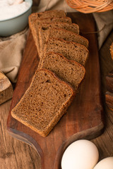 Slice of brown bread on kitchen board with eggs