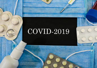 COVID-2019 on a sticker on the background of medical masks.