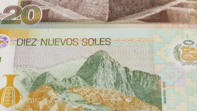 Peru sol banknotes tracking. Peruvian money. Slider shot. Low angle, 4K