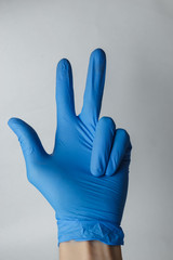hand in a medical glove, gestures. Suitable for demonstrating something on the topic of medicine or chemistry