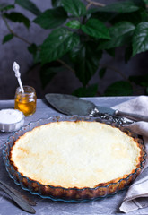 Diet cottage cheese casserole with lemon zest and vanilla, served with sour cream and honey.