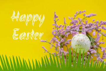 Concept of spring and Happy Easter pink and white with gold eggs on a colorful yellow bright background, grass cut out of paper