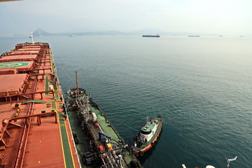 Bunkering of a ship on the open roadstead of the port of Nakhodka, Russia.
