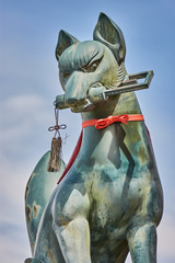 Statue of a kitsune (Japanese Shinto red fox god) in Fushimi Inari Shinto shrine in Kyoto, Japan