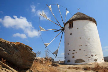 Vivlos, Naxos / Greece - August 25, 2014: Traditional windmill at the mountain village Vivlos, Naxos, Cyclades Islands, Greece
