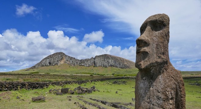 Easter Island &ndash; Moai stone statue with a view to Ranu Raraku vulcano