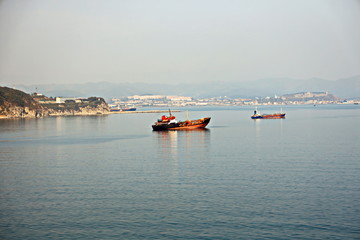 Bunkering of a ship on the open roadstead of the port of Nakhodka, Russia.