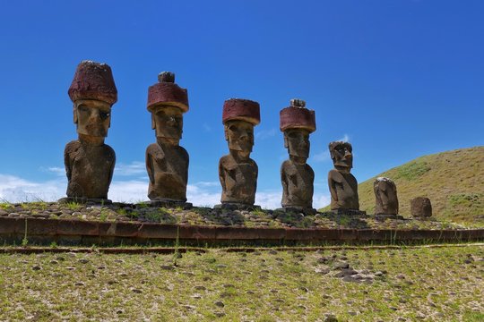 Easter Island &ndash; Moai stone statues at Anakena Beach with red Pukao