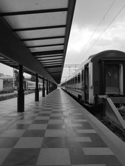 waiting train at the station black and white