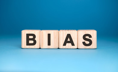 Bias - text on wooden blocks, personal opinions prejudice, blue background