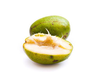 fresh green ambarella fruit that is still intact and that has been cut, isolated from a white background and copyspace, scientific name: Spondias dulcis