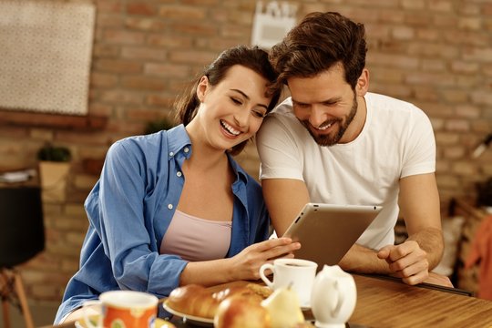 Stay at home - Happy couple with tablet computer in the morning
