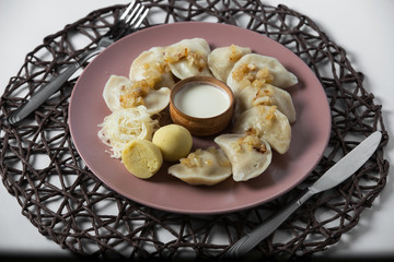 dumplings with stewed cabbage, homemade traditional Ukrainian dish varenyky