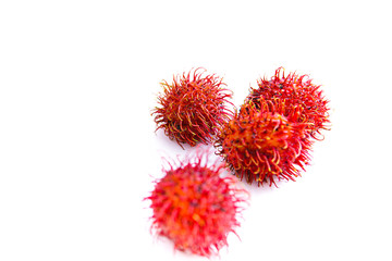 ripe red rambutan fruit, isolated white background and copyspace, scientific name: Nephelium lappaceum