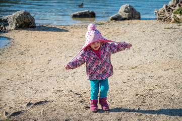 Cute girl walking and pulling her hat in a funny way.