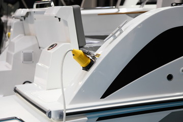 Electric plug of the shore power supply is connected to the outlet on Board the motor yacht,...