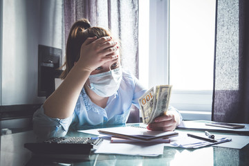 Coronavirus trigger dropping the economy in the world. Girl at home considers the budget. Virus,...