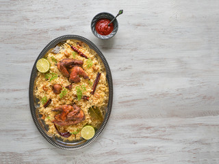 Homemade chicken Biryani. Arabic traditional food bowls Kabsa with meat