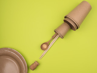 Environmental utensils on a bright green background.