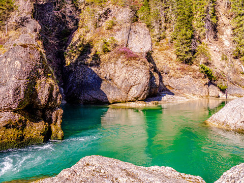 Turquoise,  from rocks surrounded water pool at the steam cutoff in the george of the river Ammer in bavaria, called "Scheibum"
