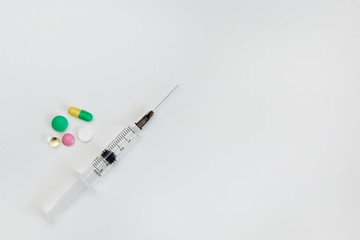 medicines in a package and a syringe