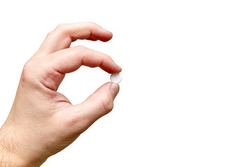 hand holds one tablet in fingers