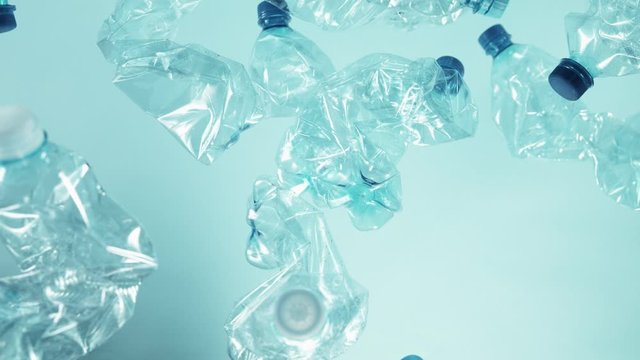 Super slow motion of empty plastic bottles flying into the air. Filmed on high speed cinema camera, 1000 fps.