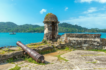 Old Spanish cannon at the fortress ruin of Santiago with a view over the Caribbean Sea in Portobelo...