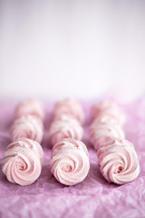 Obraz na płótnie Canvas Homemade pink marshmallows on pastel pink background. Creative concept Marshmallow, Meringue. Homemade Sweets dessert