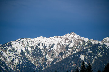 High alpine mountains with snow in Germany and blue beautiful sky