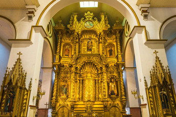 The main altar of the San Jose church in baroque style decorated with gold leaf and religious...