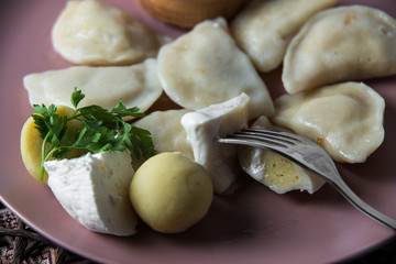Fototapeta na wymiar dumplings with potatoes, homemade traditional Ukrainian dish varenyky