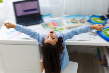 education and school online concept - smiling little student girl with many books at home schooling