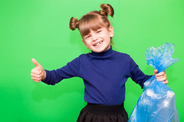 Positive little ecologist girl holding trash bag with plastic bottles and show thumb up isolated on...