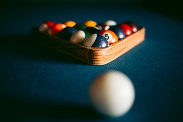 Multi-colored billiard balls on a blue table