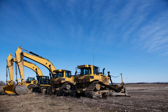 yellow excavators on construction site