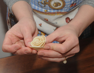A girl holds a flower in her hands during a workshop on modeling traditional Ukrainian decorative elements from bread dough (flowers, cones, birds). in Kiev, February 22, 2020