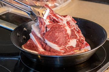 piece of steak being cooked in the pan