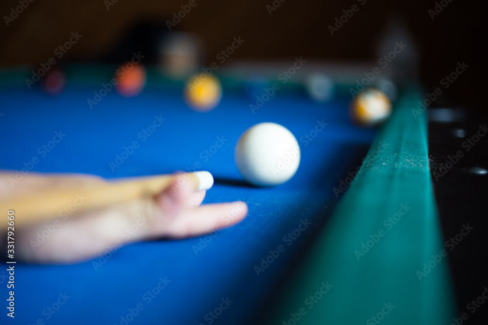 Wall mural Man plays billiards on a blue table